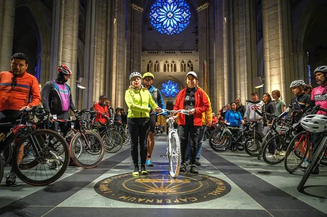 A white bicycle memorializing cyclists killed in traffic accidents is held during the 25th annual 'Blessing of the Bicycles' celebration at the Cathedral of St. John the Divine in New York city May 6, 2023. (Photo by Ed Jones/AFP Photo)