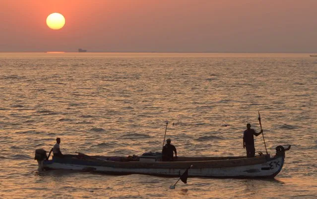 Iraqi fishermen travel in their boat in Iraqi territorial waters as the sun sets in Basra province May 17, 2014. (Photo by Essam Al-Sudanii/Reuters)