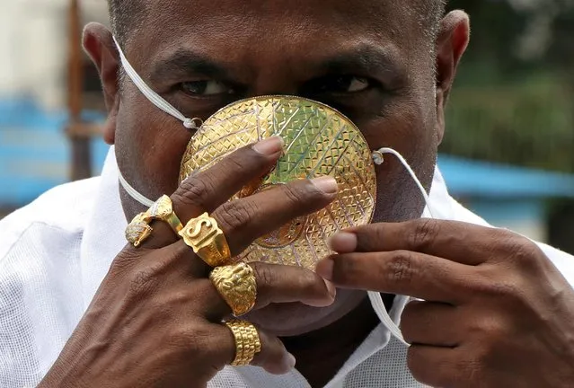 Shankar Kurhade (48), wears his face mask made out of gold as he poses for a photograph amidst the spread of the coronavirus disease (COVID-19) in Pune, India, July 4, 2020. Kurhade claims the mask weighs 50 grams and costs around $3870. (Photo by Reuters/Stringer)