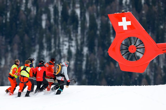 Michelle Gisin of Switzerland is being carried on a stretcher after a fall during an alpine ski, women's World Cup downhill training, in St. Moritz, Switzerland, Thursday, December 11, 2025. (Photo by Jean-Christophe Bott/Keystone via AP Photo)