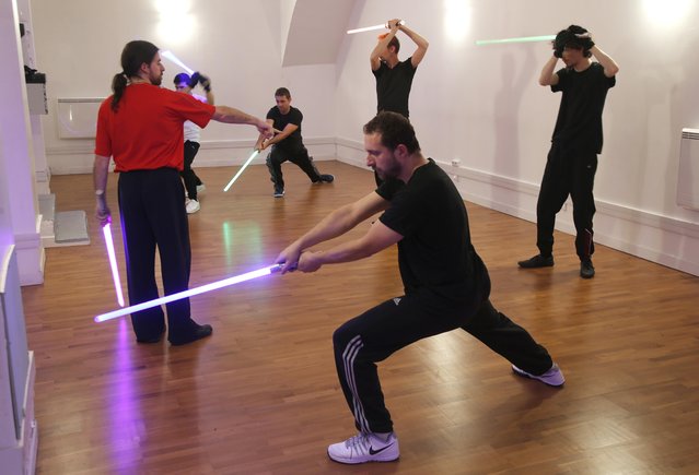 Members of the Sport Saber League practise light saber during a training session in Paris, France, November 10, 2015. (Photo by Charles Platiau/Reuters)
