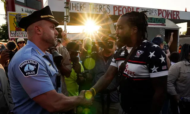 Minneapolis Police Chief Brian O'Hara, left, shakes hands with Michael Wilson on the three-year anniversary of George Floyd's death at George Floyd Square, Thursday, May 25, 2023, in Minneapolis. The murder of Floyd at the hands of Minneapolis police, and the fervent protests that erupted around the world in response, looked to many observers like the catalyst needed for a nationwide reckoning on racism in policing. (Photo by Abbie Parr/AP Photo)