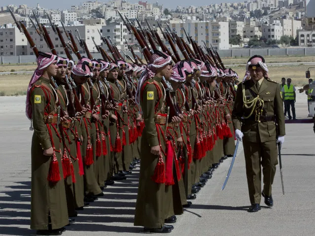 A Jordanian army officer inspects the honor guard in preparation for the arrival of Britain's Prince William, at Marka Airport in Amman, Jordan, Sunday, June 24, 2018. Britain's Prince William kicked off a politically delicate five-day tour of Jordan, Israel and the Palestinian territories. He plans to meet with young people, refugees and political leaders in a tumultuous region Britain had controlled between the two world wars. (Photo by Nasser Nasser/AP Photo)