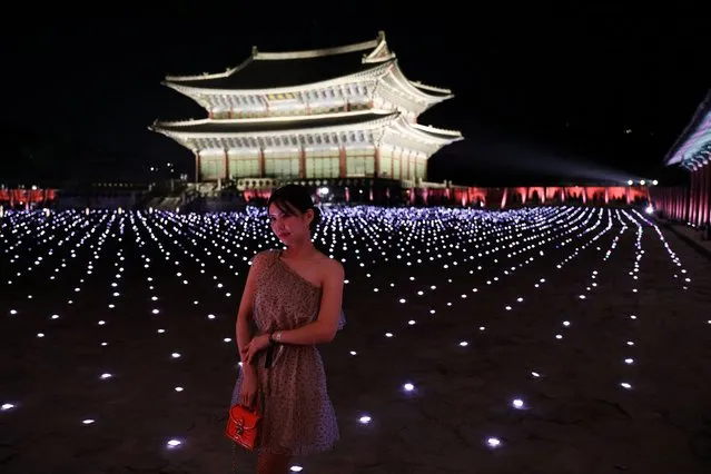 A woman poses for photographs after Gucci Cruise 2024 collection fashion show at the Gyeongbok Palace in Seoul, South Korea on May 16, 2023. (Photo by Kim Soo-Hyeon/Reuters)