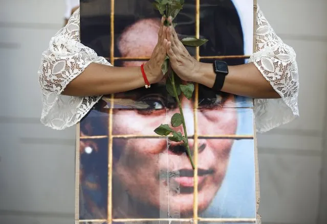 A Myanmar woman living in Thailand holds a rose as she prays for coup ousted detained leader Aung San Suu Kyi during a protest against Indonesian government's alleged support to the junta, at the Indonesian embassy in Bangkok, Thailand, 23 February 2021. Anti-coup protesters gathered to protest following media reports suggesting that Indonesian government is supporting a plan to send observers to Myanmar to ensure that military coup leaders will hold new elections, while protesters are rejecting the suggested plan and want the ousted government to be restored. Myanmar's Aung San Suu Kyi and other top political leaders have been detained after a raid in a military coup due to a tension rising between civilian government and the military disputed from the November 2020 elections results. (Photo by Rungroj Yongrit/EPA/EFE)