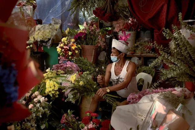 Filipino flower vendors preparing their products on the eve of Valentines day amidst the threat of new variants of the Corona Virus, on February 13, 2021 in Manila, Philippines. (Photo by Jes Aznar/Getty Images)