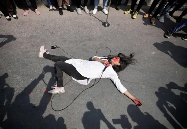 A woman performs an act against the growing incidents of violence on women during International Women's Day in Kathmandu, Nepal on March 8, 2021. (Photo by Navesh Chitrakar/Reuters)