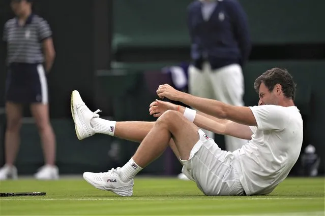 Quentin Halys of France falls during the first round men's singles match against Britain's Daniel Evans on day two of the Wimbledon tennis championships in London, Tuesday, July 4, 2023. (Photo by Alberto Pezzali/AP Photo)