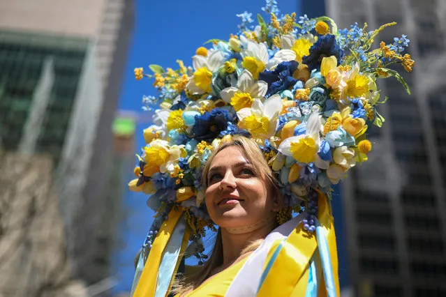 Larissa Larina, originally from Ukraine, wears a Ukrainian flag colored floral headpiece at the annual Easter Parade and Bonnet Festival along Fifth Avenue on Easter Sunday on April 17, 2022 in New York City. The annual Easter Parade and Bonnet Festival returned this year after being canceled in 2020 and officially held virtually in 2021, although people filled the streets and participated anyway. (Photo by Alexi Rosenfeld/Getty Images)