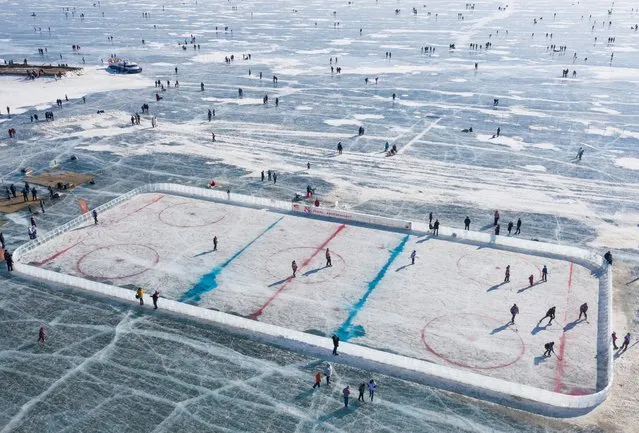 An aerial view shows a hockey rink after a match on the ice of Lake Baikal, organized to draw attention to the environmental problems of the lake, in the village of Bolshoye Goloustnoye in Irkutsk region, Russia on March 8, 2021. Picture taken with a drone. (Photo by Maxim Shemetov/Reuters)