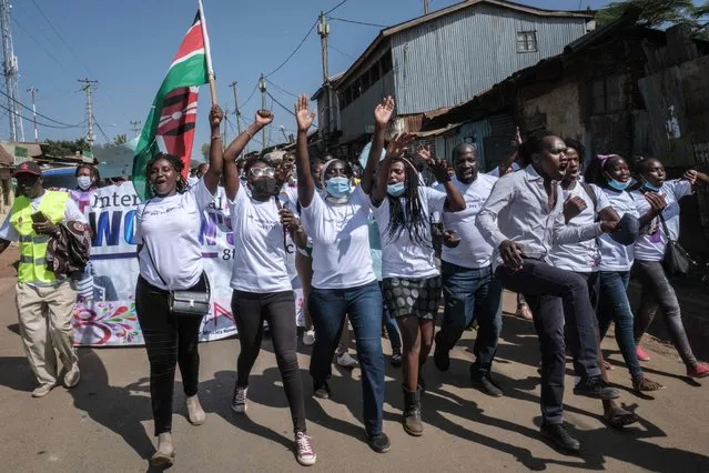 Women human rights defenders from 26 community based organisations march to commemorate International Women's Day in Kibera, Nairobi, on March 8, 2021. (Photo by Yasuyoshi Chiba/AFP Photo)