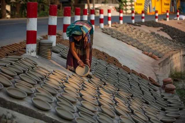 Newly made pots kept in the sun to get dry in Munshiganj outskirts of Dhaka on March 16, 2021. Pottery is one of the sources of income for a limited number of families in Bangladesh. (Photo by Ahmed Salahuddin/NurPhoto/Rex Features/Shutterstock)