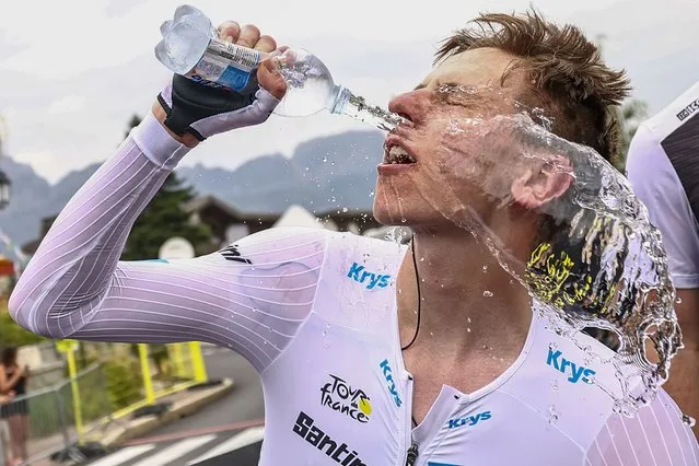 Slovenia's Tadej Pogacar, wearing the best young rider's white jersey, cools off after the sixteenth stage of the Tour de France cycling race, an individual time trial over 22.5 kilometers (14 miles) with start in Passy and finish in Combloux, France, Tuesday, July 18, 2023. (Phoot by Anne-Christine Poujoulat/Pool Photo via AP Photo)