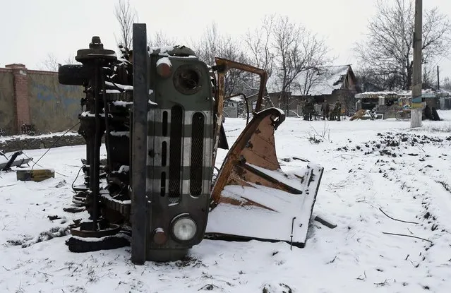 A military car, damaged during fighting between pro-Russian rebels and Ukrainian government forces, is seen on the roadside in the town of Vuhlehirsk, eastern Ukraine February 10, 2015. (Photo by Maxim Shemetov/Reuters)