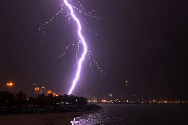 Lightning flashes over Kuwait City during a thunderstorm on March 26, 2023. (Photo by Yasser Al-Zayyat/AFP Photo)