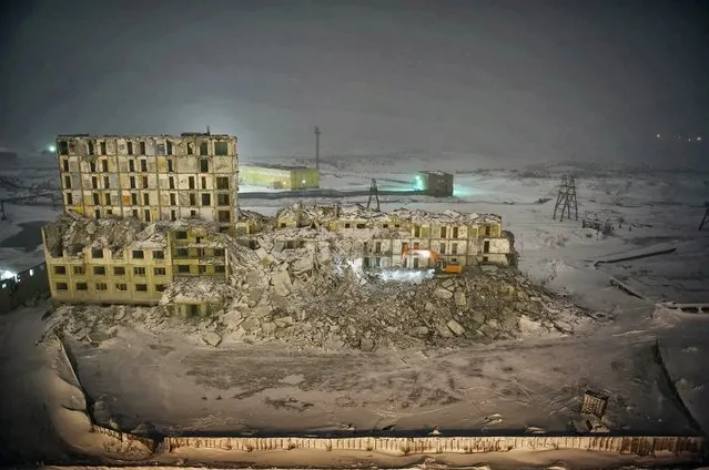 2012. A bulldozer demolishes a building. Norilsk is facing an infrastructure crisis due to melting permafrost, on which most of its buildings were set. The thaw is caused by the leeching of sewage and hot water into the ground, urban development in general, global warming and pollution. (Photo by Elena Chernyshova)