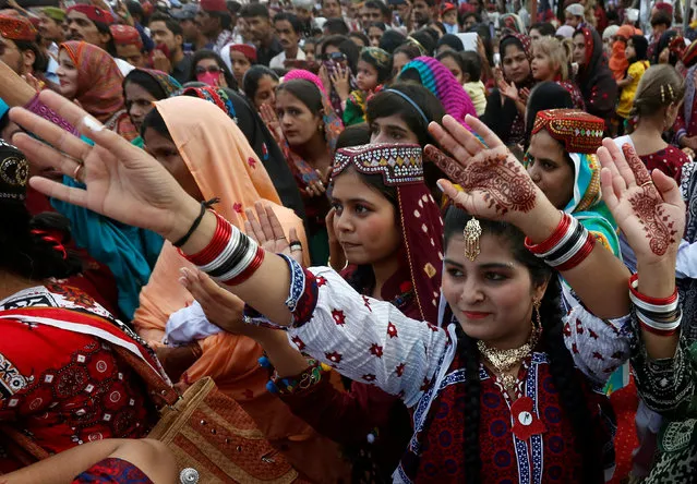 A woman dances with others during Sindh Culture Day in Karachi, Pakistan, December 4, 2016. (Photo by Akhtar Soomro/Reuters)