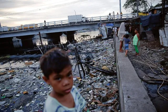 Local residents pass the time under C-3 bridge in North Bay Boulevard South (NBBS), a Navotas City district of slums and waterways with a high number of drug war deaths, in Manila, Philippines November 3, 2016. (Photo by Damir Sagolj/Reuters)