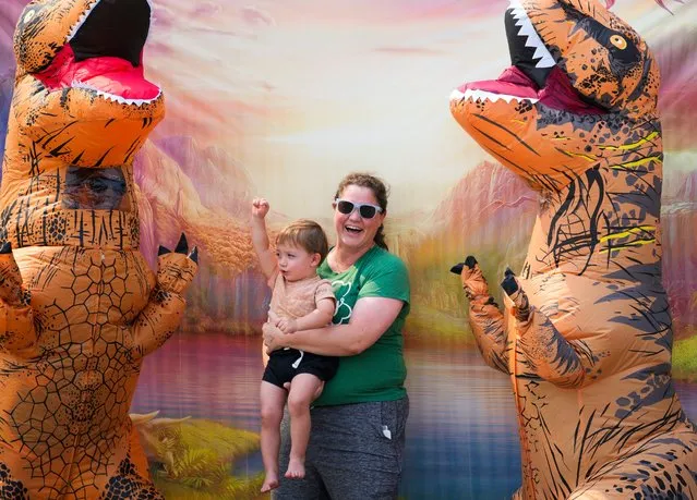 Kate McArthur laughs while taking a photo with Coen, 2, before the “T-Rex World Championship Races” at Emerald Downs, Sunday, August 20, 2023, in Auburn, Wash. (Photo by Lindsey Wasson/AP Photo)