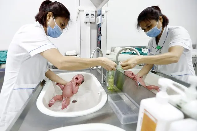 A nurse bathes a newborn baby at a hospital in Hanoi, Vietnam on July 11, 2023. Viet Nam’s population is is estimated to reach 100 million in 2023. World Population Day is observed on 11 July annually since it was established by the United Nations in 1989. This year, World Population Day's theme is “Unleashing the power of gender Equality: Uplifting the voices of women and girls to unlock our world's infinite possibilities”. (Photo by Luong Thai Linh/EPA/EFE)
