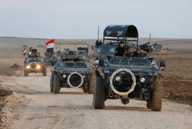 Iraqi security forces ride on military vehicles during clashes with Islamic State militants, north of Mosul, Iraq, December 29, 2016. (Photo by Ammar Awad/Reuters)