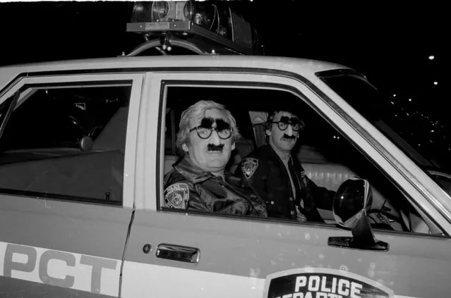 Policemen from an upper Manhattan precinct, dressed in matching Groucho masks, gaze from the window of their car on Halloween night, October 31, 1980. (Photo by AP Photo/Luongo)