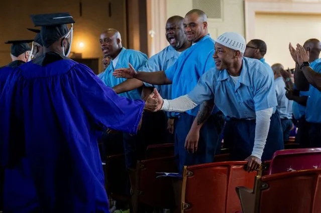 Prisoners currently in the Northwestern Prison Education Program congratulate their peers who are graduating from the program before they receive their bachelor's degrees from Northwestern University during a graduation ceremony for students who went through the inaugural class of the Northwestern Prison Education Program at Stateville Correctional Center in Crest Hill, Illinois, U.S., November 15, 2023. (Photo by Vincent Alban/Reuters)