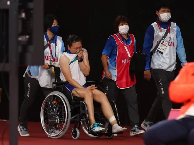 Beiwen Zhang(in wheelchair) of Team United States reacts after suffered a match-ending injury during a Women's Singles Round of 16 match against He Bing Jiao of Team China on day six of the Tokyo 2020 Olympic Games at Musashino Forest Sport Plaza on July 29, 2021 in Chofu, Tokyo, Japan. (Photo by Leonhard Foeger/Reuters)