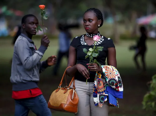 A woman carries a rose as she arrives for a memorial vigil for the people killed by gunmen at Garissa University College, at the “Freedom Corner” in Nairobi April 7, 2015. (Photo by Goran Tomasevic/Reuters)