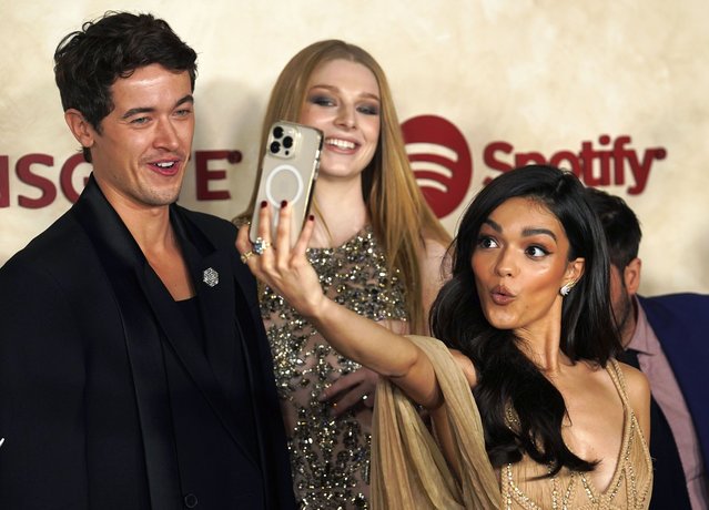 Rachel Zegler, right, a cast member in “The Hunger Games: The Ballad of Songbirds & Snakes”, shoots a selfie with fellow cast members Tom Blyth, left, and Hunter Schafer at the Los Angeles premiere of the film, Monday, November 13, 2023, at the TCL Chinese Theatre. (Photo by Chris Pizzello/AP Photo)