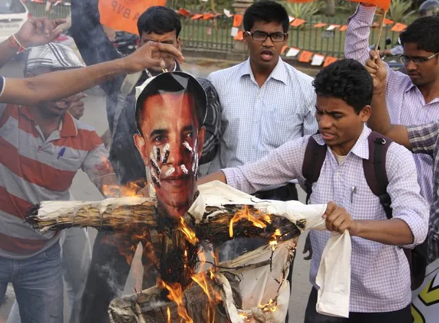 Activists of Akhil Bharatiya Vidyarthi Parishad (ABVP), linked to India's main opposition Bharatiya Janata Party (BJP), burn an effigy depicting U.S. President Barack Obama during a protest in the eastern Indian city of Bhubaneswar December 19, 2013. India urged the United States to withdraw a visa fraud case against one of its diplomats in New York on Thursday, suggesting U.S. Secretary of State John Kerry's expression of regret over her treatment while in custody was not enough. (Photo by Reuters/Stringer)