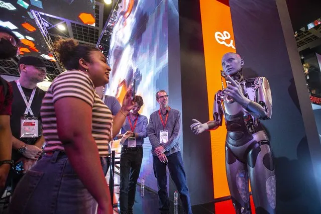 Visitors interacting with AI-powered robot at GITEX Technology, Dubai World Trade Centre on October 10, 2022.  (Photo by Leslie Pableo for The National)