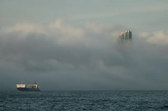 The 67-storey-high “The Masterpiece”, one of Hong Kong's most luxurious high-rise residential buildings, is seen during foggy conditions under the influence of a warm maritime airstream at sunset in Hong Kong in this March 21, 2011 file photo. Hong Kong is expected to report trade data this week. (Photo by Tyrone Siu/Reuters)