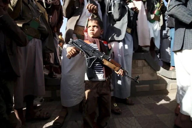 A boy stands among followers of the Houthi group during a demonstration against an arms embargo imposed by the U.N. Security Council on the group in Sanaa April 16, 2015. (Photo by Mohamed al-Sayaghi/Reuters)