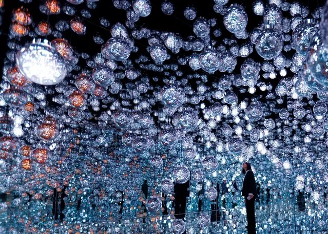 A member of the teamLab digital art group looks around an installation in preparation for the reopening of their Borderless museum in February at the Azabudai Hills complex in Tokyo, Japan on November 17, 2023. (Photo by Kim Kyung-Hoon/Reuters)