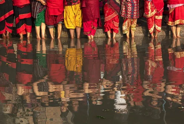 Nepalese Hindu devotees attend mass prayer during the first day of the month-long Madhav Narayan festival in Bhaktapur, Nepal, on 25 January 2024. The Madhav Narayan festival takes place for an entire month. It is devoted to religious fasting, holy bathing, and the study of the Swasthani book, a chapter or story read each evening by priests or heads of households to the gathered family. Thousands of married women and dozens of male devotees concluded their month-long fast at various temples for a better life and peace in the country. According to the Swasthani book, whoever takes the month-long Swasthani fast will have all their sins forgiven, and they will not experience bad days during their life. The festival is dedicated to Lord Shiva, the god of creation and destruction. (Photo by Narendra Shrestha/EPA)