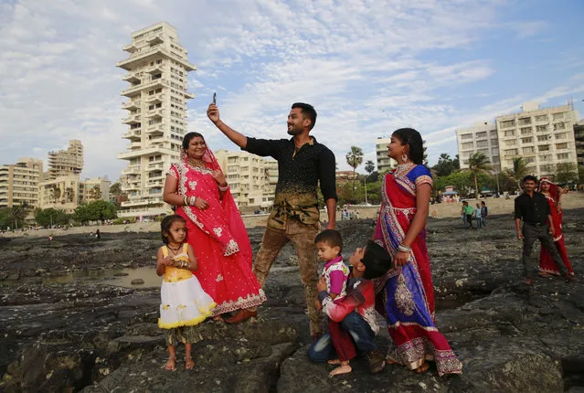 In this February 22, 2016, photo, an Indian family takes a selfie in Mumbai's coastline. India is home to the highest number of people who have died while taking photos of themselves, with 19 of the world's 49 recorded selfie-linked deaths since 2014, according to San Francisco-based data service provider Priceonomics. The statistic may in part be due to India's sheer size, with 1.25 billion citizens and one of the world's fastest-growing smartphone markets. (Photo by Rafiq Maqbool/AP Photo)