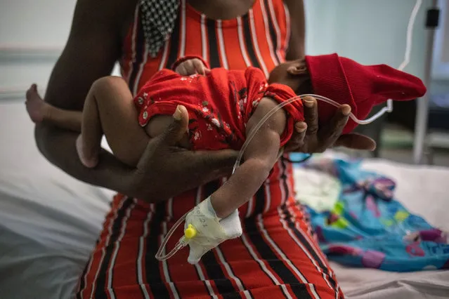 Omide Marechal, 61, holds her 26-day-old grandson Peterson Espadieu on a hospital bed at the Centre Hospitalier du Sacre-Coeur in Port-au-Prince, Haiti, October 28, 2021. Peterson's mother died during childbirth. Haiti's hospitals are at risk of closing for lack of fuel and the lives of hundreds of thousands of women and children are at risk, United Nations children's agency UNICEF reported. (Photo by Adrees Latif/Reuters)