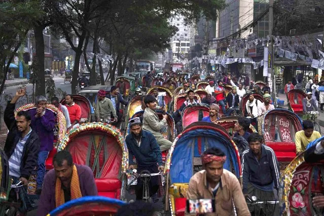 Supporters and activists of Gono Odhikar Porishod party ride rickshaws during a protest march demanding free and fair elections and supporting the boycott of Sunday's parliamentary elections, in Dhaka, Bangladesh, Friday, January 5, 2024. Bangladesh's main opposition party called for general strikes on the weekend of the country's parliamentary election, urging voters to join its boycott. This year, ballot stations are opening amid an increasingly polarized political culture led by two powerful women; current Prime Minister Sheikh Hasina and opposition leader and former premier Khaleda Zia. (Photo by Altaf Qadri/AP Photo)