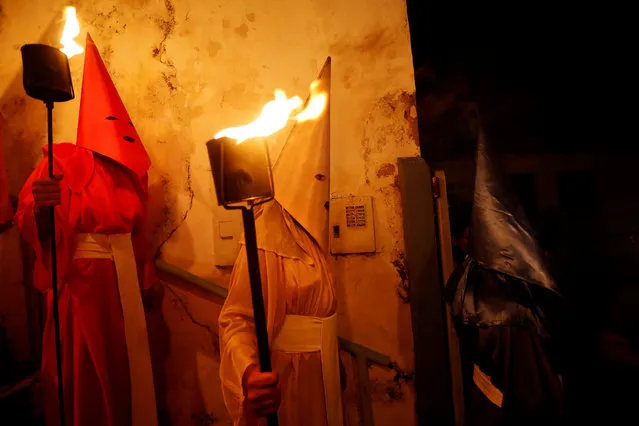 Penitents attend the Procession of the Torches during Holy Week in Goias Velho, west of Brasilia, Brazil April 18, 2019. (Photo by Adriano Machado/Reuters)