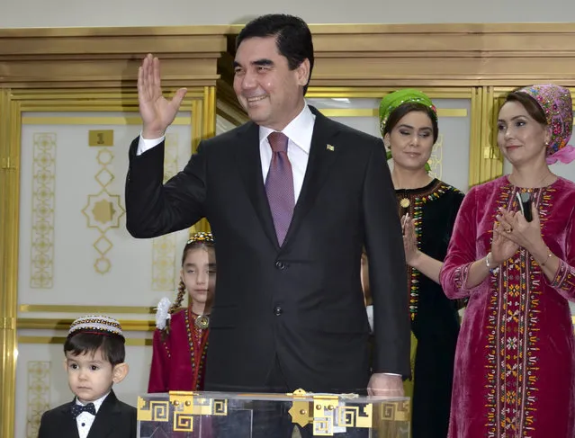 Turkmenistan President Gurbanguly Berdimuhamedov, center, greets journalists after casting his ballot at a polling station in Ashgabat, Turkmenistan, Sunday, February 12, 2017. Berdymukhamedov has been the overwhelmingly dominant figure in the former Soviet republic for a decade, when he assumed power after death of his eccentric predecessor Saparmurat Niyazov. (Photo by Alexander Vershinin/AP Photo)
