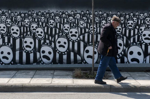 A man walks past a graffiti dedicated to the Holocaust in the northern port city of Thessaloniki March 15, 2015. Jews gathered at the northern town of Greece for an event organised by the Thessaloniki Jewish community marking the first deportation of Thessaloniki Jews to Nazi death camps during World War Two. (Photo by Alexandros Avramidis/Reuters)