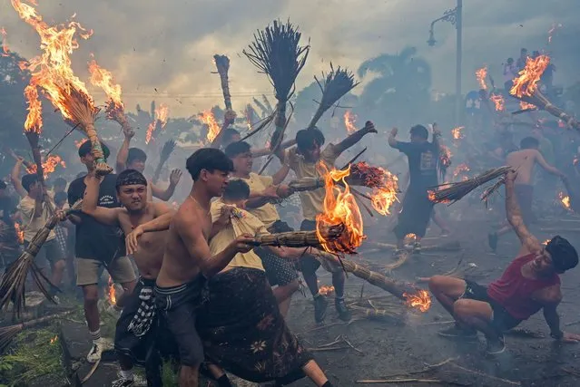 Hindu worshipers take part during the “Perang Api”, a war of fire tradition that is believed for cleansing the evil elements and keeping away from misfortune, ahead of Nyepi Day, a day of silence for self-reflection marking the Balinese Hindu new year in Mataram, Lombok island, Indonesia, March 10, 2024, in this photo taken by Antara Foto. (Photo by Ahmad Subaidi/Antara Foto via Reuters)