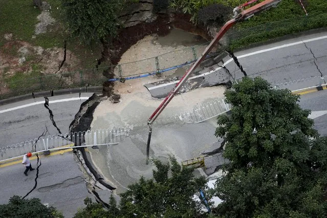 A road is being repaired after it collapsed in a heavy rain, in Guangzhou, Guangdong province, China, May 4, 2015. (Photo by Reuters/Stringer)