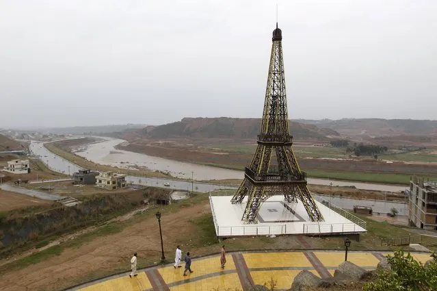 A replica of the Eiffel Tower is seen on a hill in an area being developed in Bahria Town on the outskirts of Islamabad, Pakistan March 16, 2016. (Photo by Caren Firouz/Reuters)