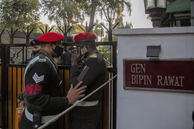 Military police personnel stand outside the residence of Chief of Defense Staff Bipin Rawat in New Delhi, India, Wednesday, December 8, 2021. India’s air force says an army helicopter carrying the country’s military chief has crashed in southern Tamil Nadu state. The air force did not say whether Rawat was injured in the accident. (Photo by Altaf Qadri/AP Photo)