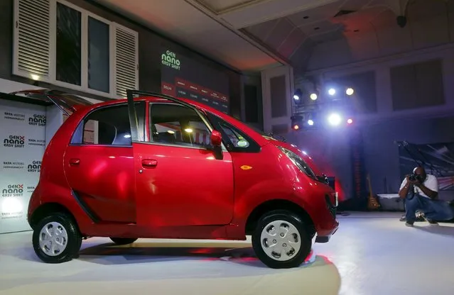 A photographer takes pictures of Tata Motors' new “GenX Nano” car during its launch in Mumbai, India, May 19, 2015. (Photo by Shailesh Andrade/Reuters)