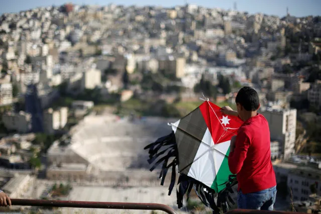 A boy flies his kite decorated with the Jordanian national flag during an event celebrating spring at the Citadel in Amman, Jordan, April 15, 2016. (Photo by Muhammad Hamed/Reuters)