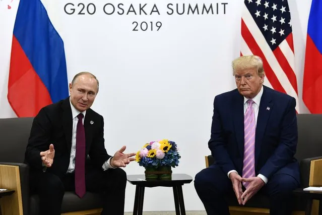 US President Donald Trump (R) attends a meeting with Russia's President Vladimir Putin during the G20 summit in Osaka on June 28, 2019. (Photo by Brendan Smialowski/AFP Photo)