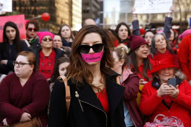 A woman with tape over her mouth takes part in a 'Day Without a Woman' march on International Women's Day in New York, U.S., March 8, 2017. (Photo by Lucas Jackson/Reuters)